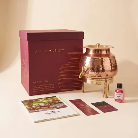 The dispenser next to its pink box and booklet