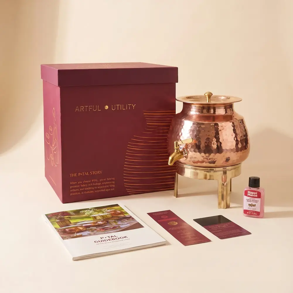 The dispenser next to its pink box and booklet