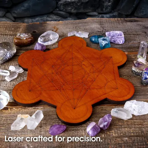 The board with crystals laid out on a dark wooden table