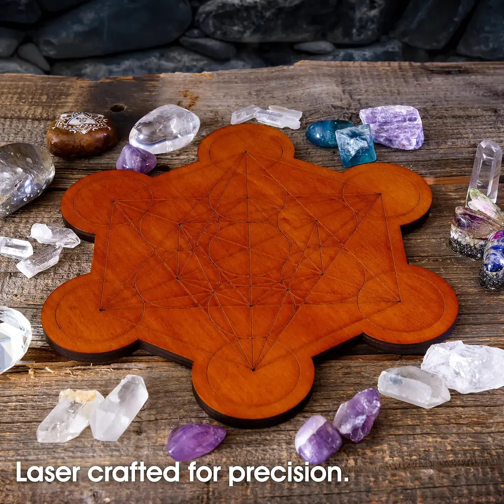 The board with crystals laid out on a dark wooden table