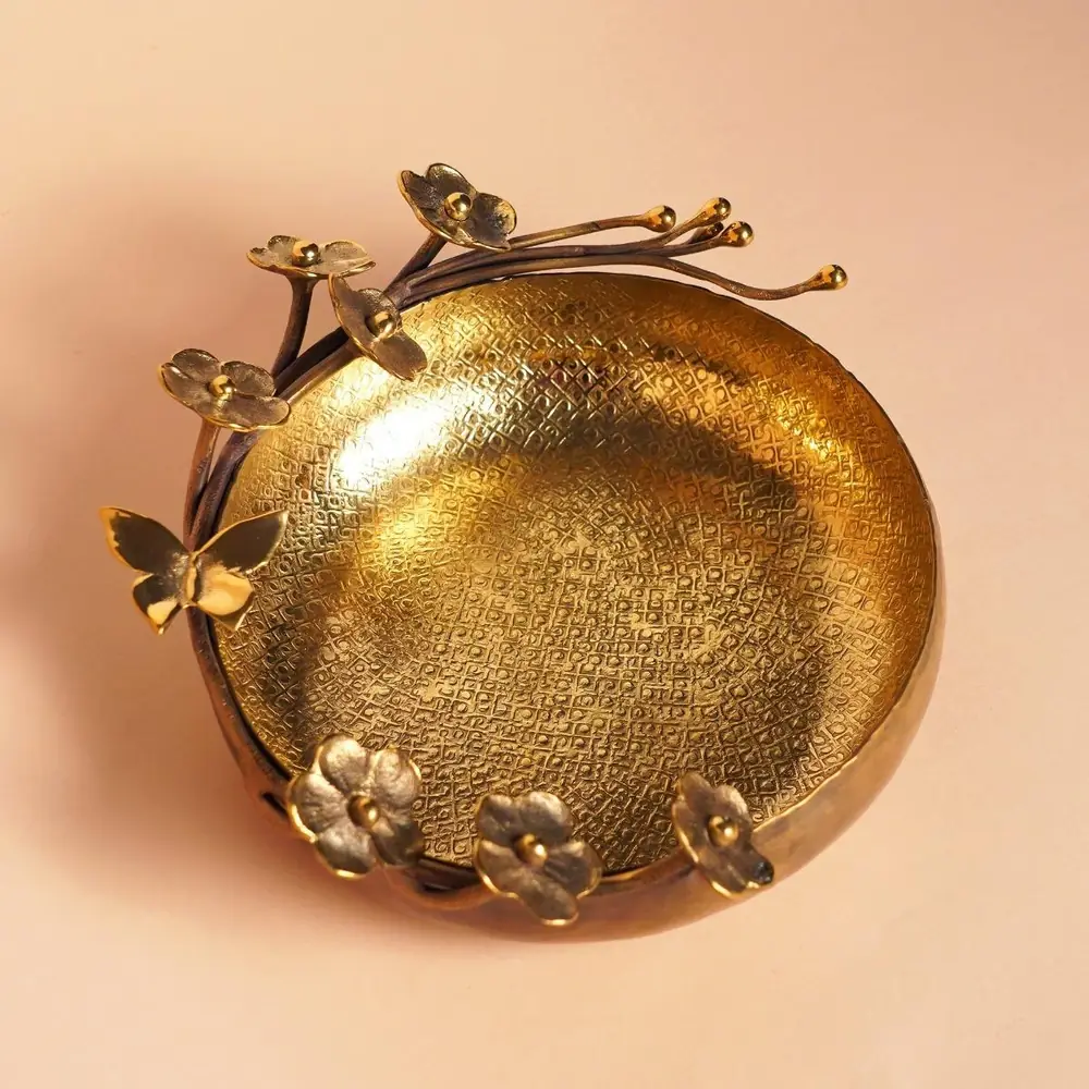 Gold-toned Daisy Blossom uruli seen from above with flowers along the rim