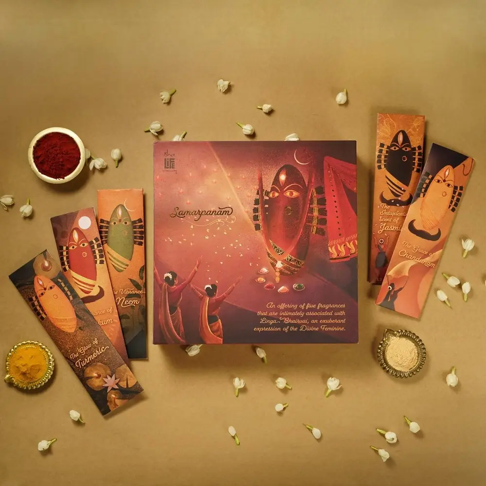 Devi Samarpanam incense gift box laid out with a bowl of kumkum and flowers