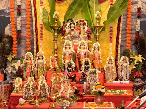 Altar with many deity images, set up for a puja