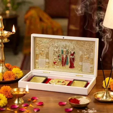 The pocket temple on a table with a lamp, flowers and kumkum