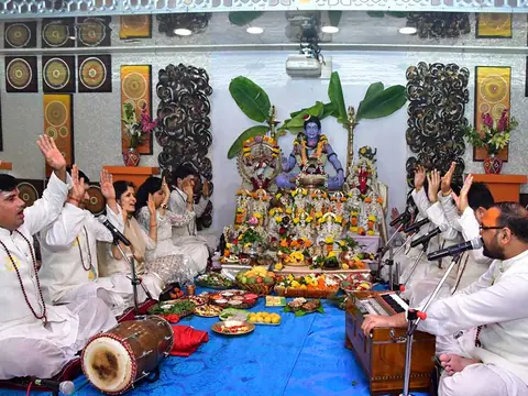 Priests and devotees chanting in front of the altar