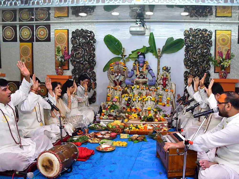 Priests and devotees chanting in front of the altar
