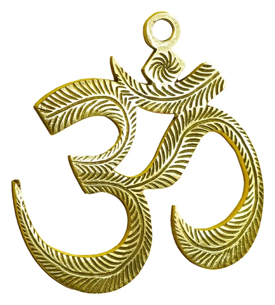 Brass Om wall hanging on a yellow ground