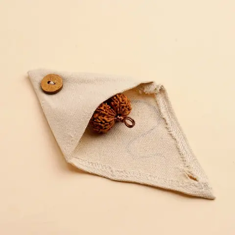 Cream cloth pouch with the bead inside