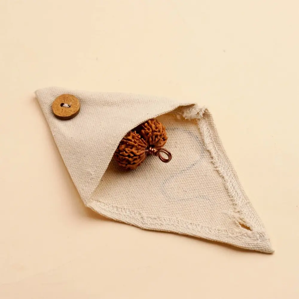 Cream cloth pouch with the bead inside