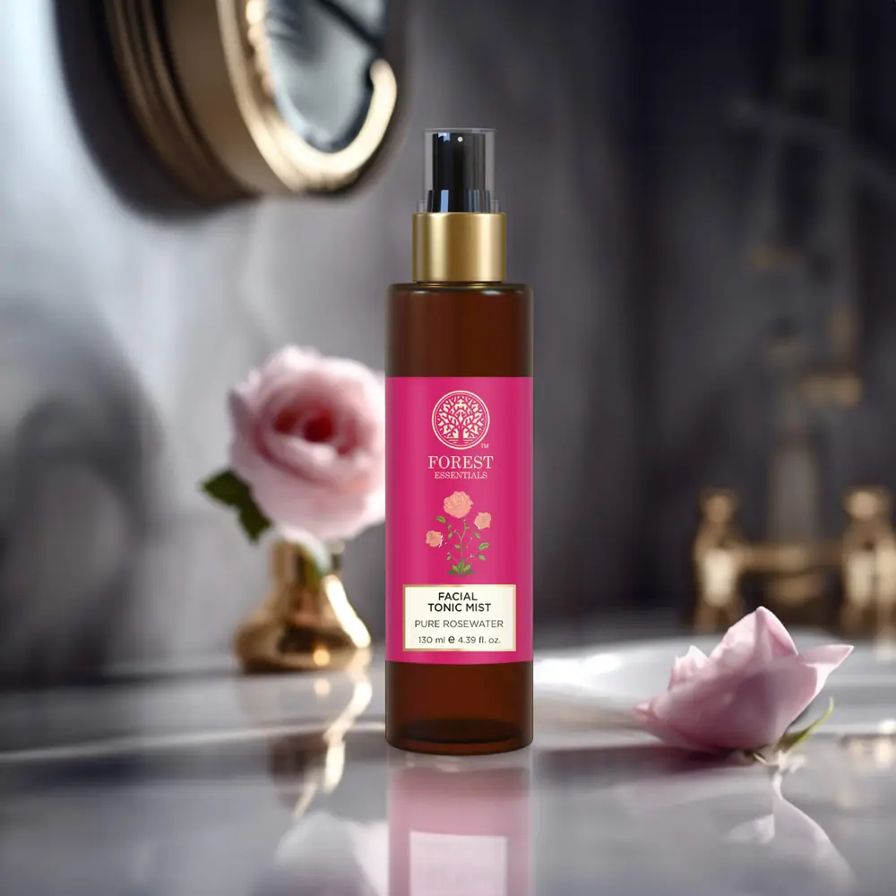 The bottle on a shelf with a pink rose beside it