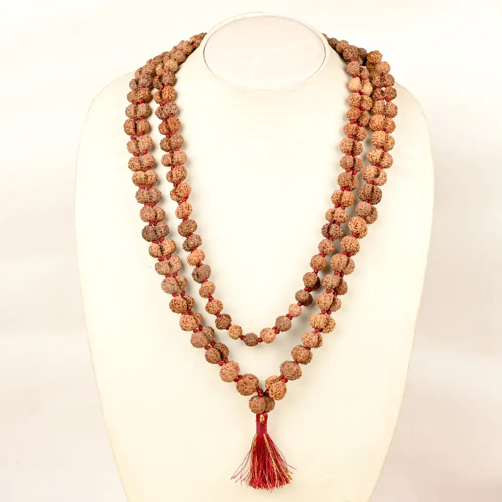 The mala hung on a mannequin bust