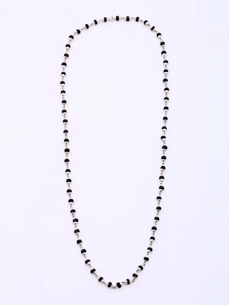 Karungali bead mala laid out as a long loop
