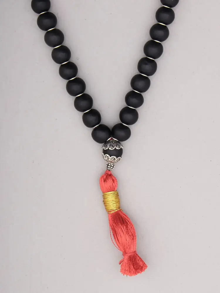 Close view of the silver cap and orange tassel