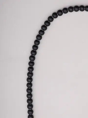 Close view of the black wooden beads
