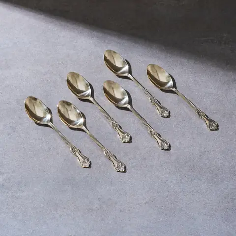 Six brass spoons with engraved handles