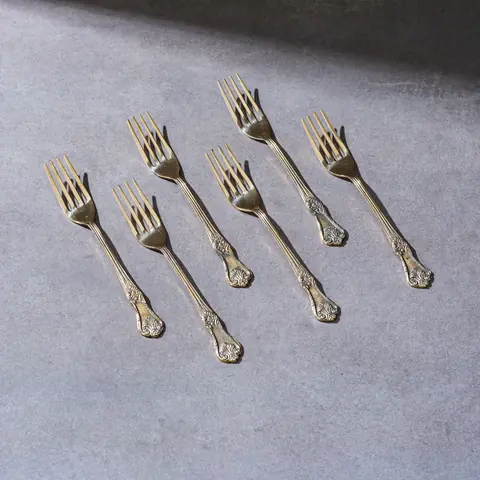 Six brass forks with engraved handles