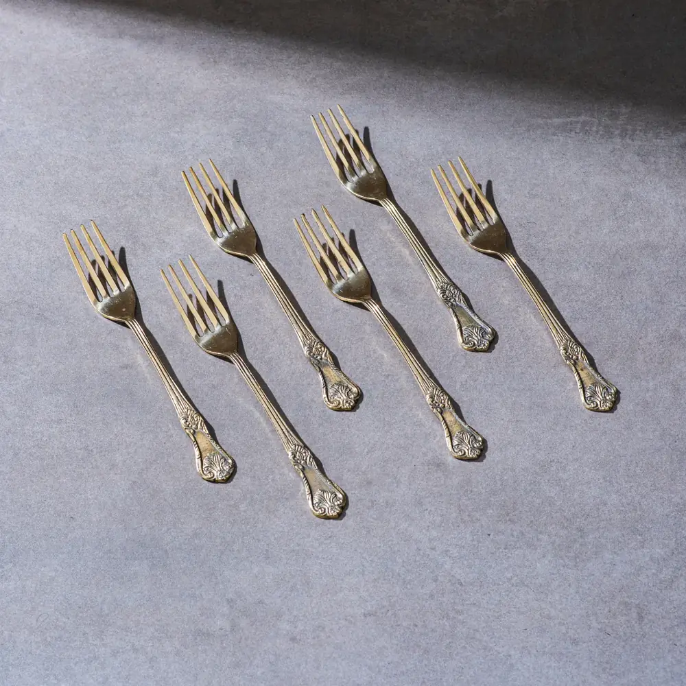 Six brass forks with engraved handles