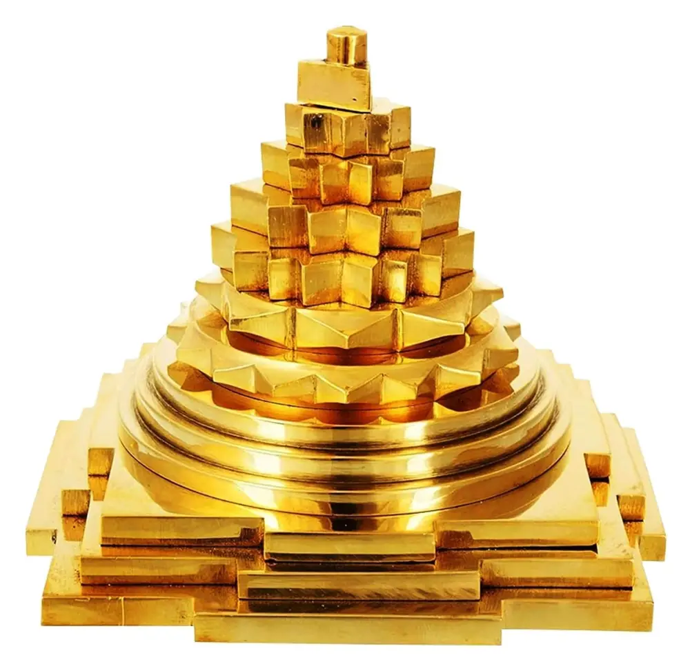 Gold brass Maha Meru Shree Yantra on a white ground