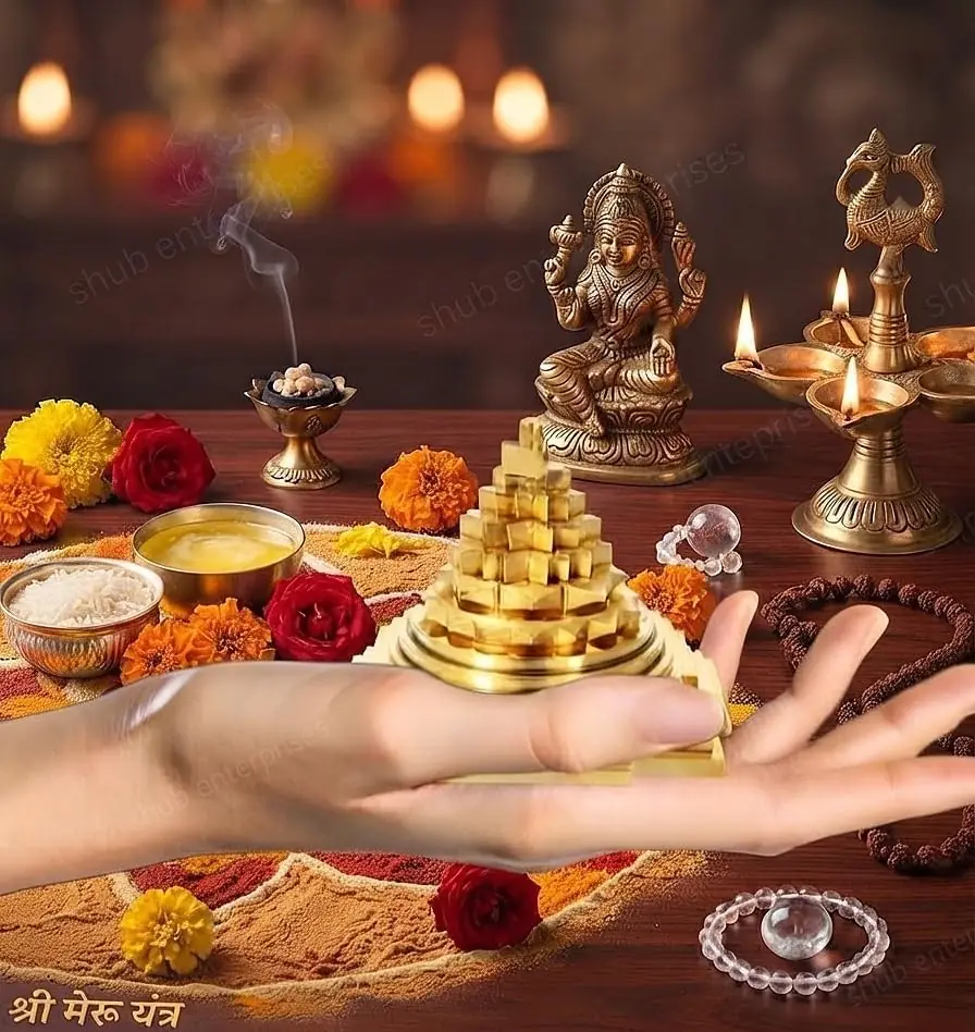 The yantra on a puja setting with flowers and lamps