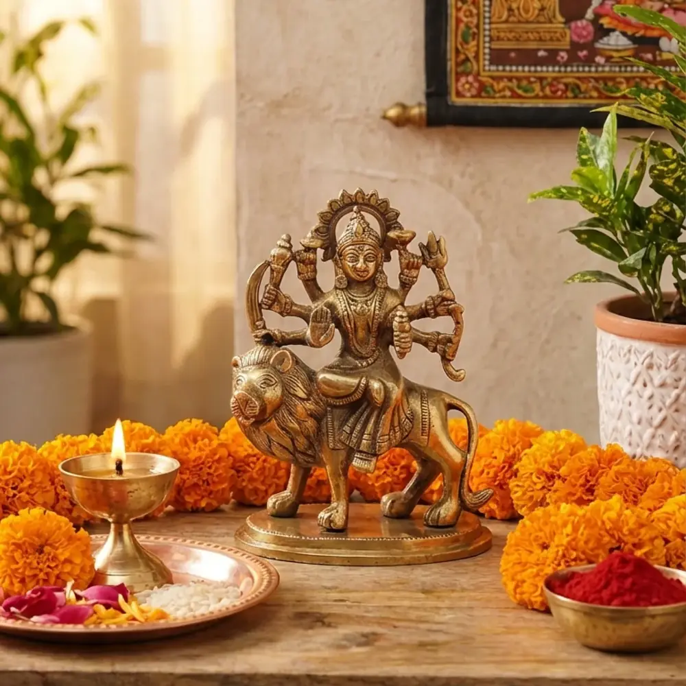 The idol on a shelf with lamps and marigolds