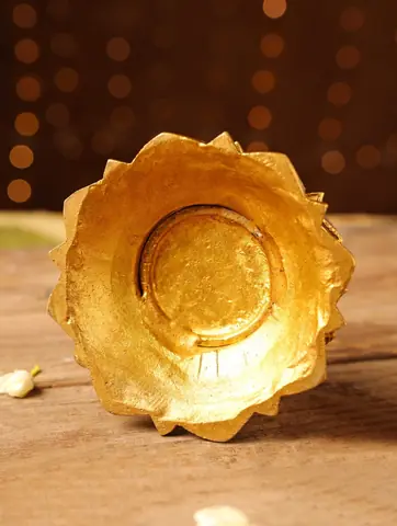 The empty brass bowl in the shape of a lotus