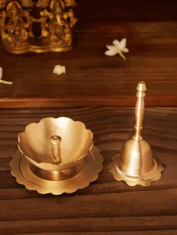 Brass bell and lotus petal holder on grey