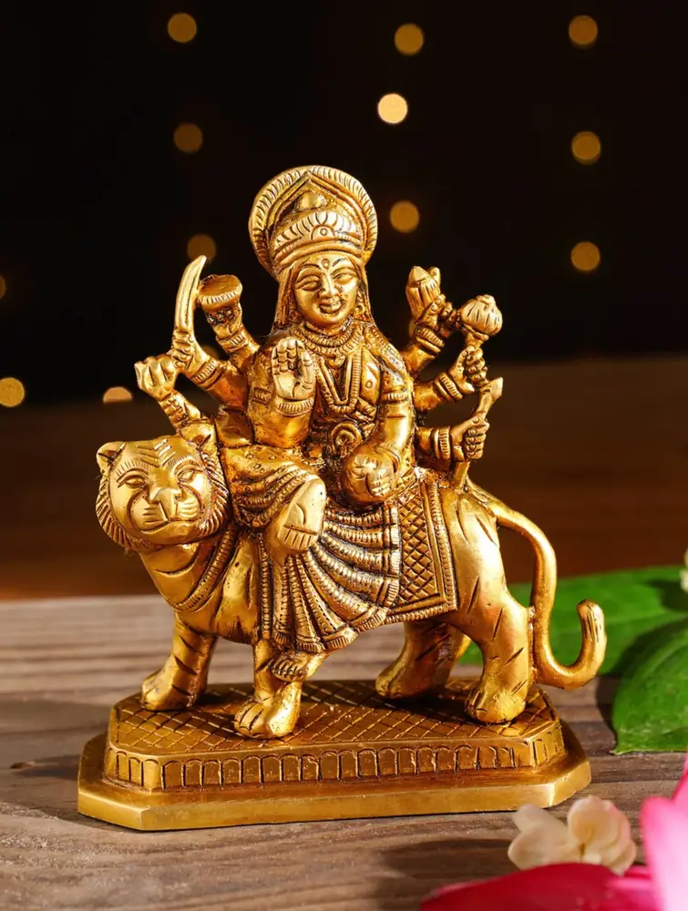 Brass Durga seated on a lion, three-quarter view
