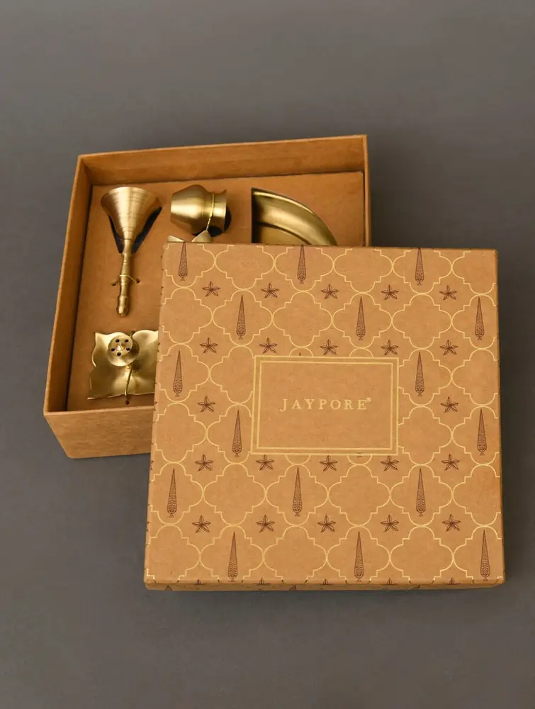 Open gift box with brass pieces packed inside