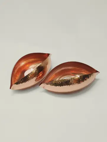 Two holders beside a small brass bud