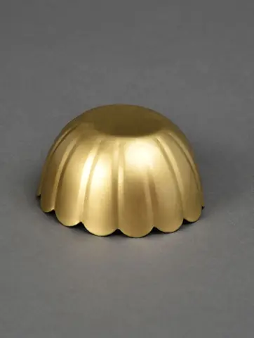 One empty gold bowl on a grey ground