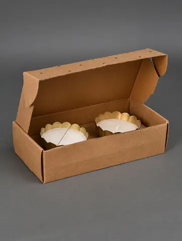 Two bowls lying in an open brown gift box