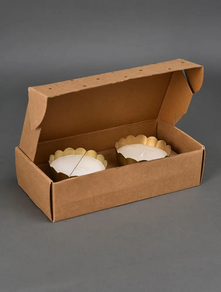 Two bowls lying in an open brown gift box