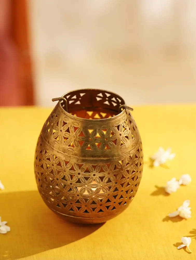 Egg-shaped gold iron holder with cut-out pattern