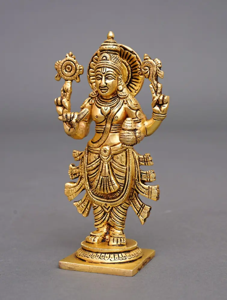 Golden brass Dhanvantari idol, front view on grey