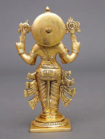 The idol seen from behind with a round disc