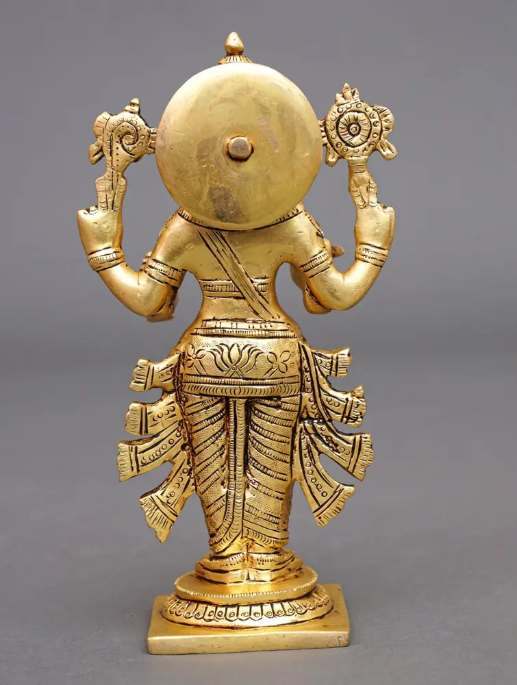 The idol seen from behind with a round disc
