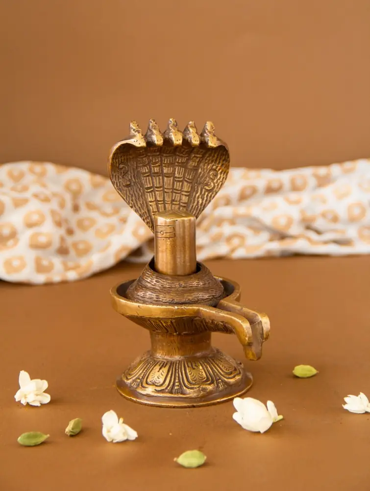 Brass Shivling with a five-hooded serpent among flowers