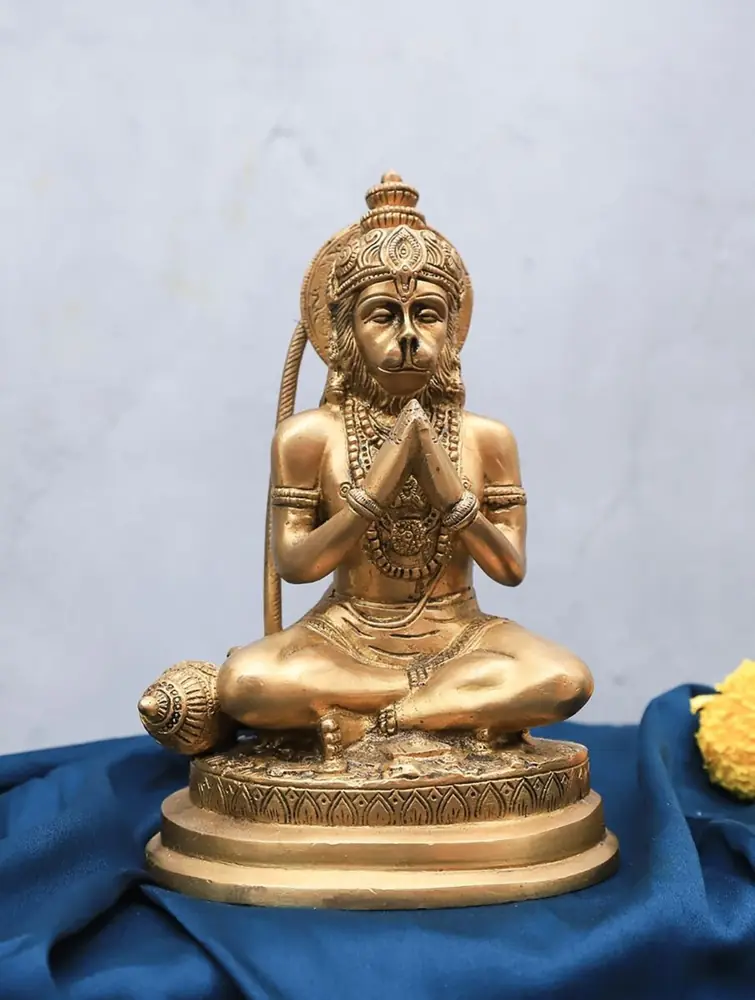 Seated brass Hanuman with joined palms on blue cloth
