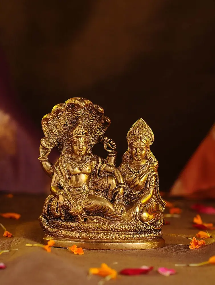Brass Vishnu under a serpent hood with Lakshmi beside him