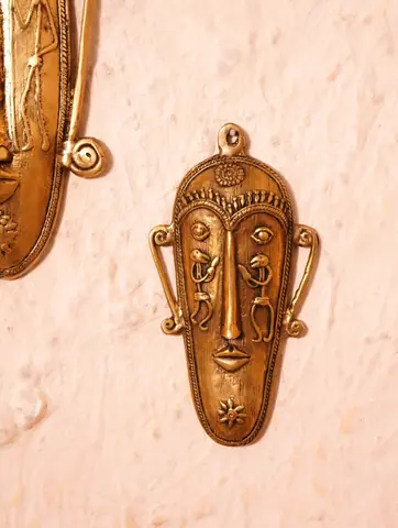 A second mask seen against the wall