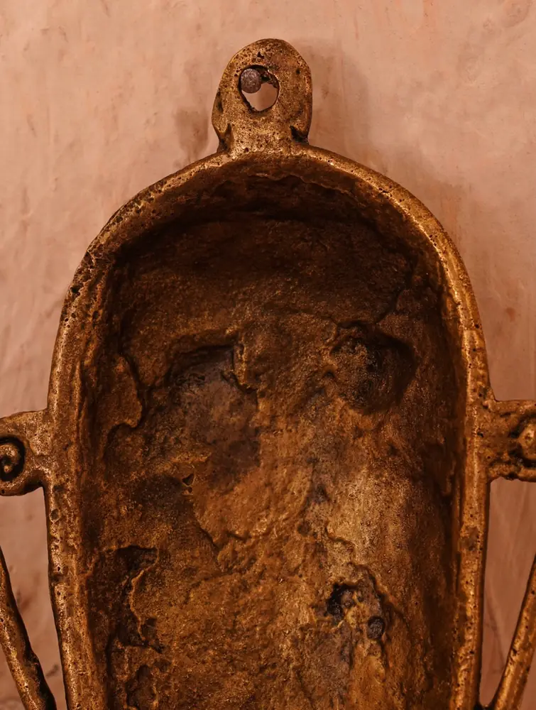 The back of a mask showing its rough, hollow cast
