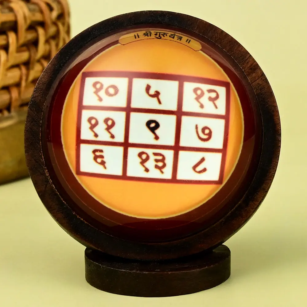 Guru yantra grid in a round wooden frame on a stand