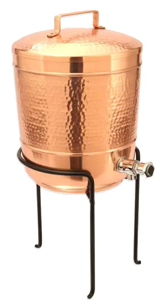 Hammered copper pot on a black iron stand, with the tap on the right