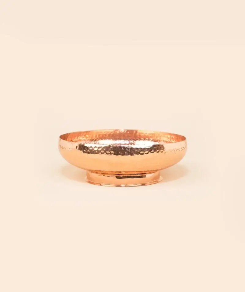 Side view of the copper uruli showing its low rim