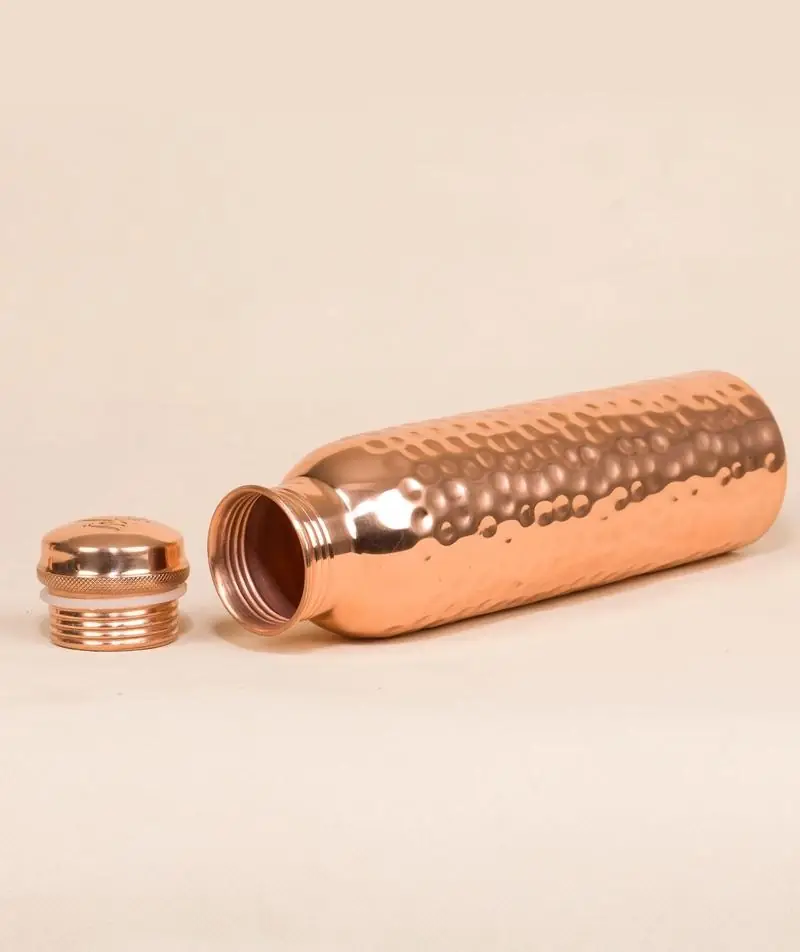 The bottle lying down with its cap beside it