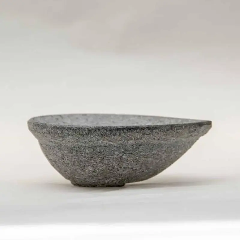 Side view of a grey stone diya
