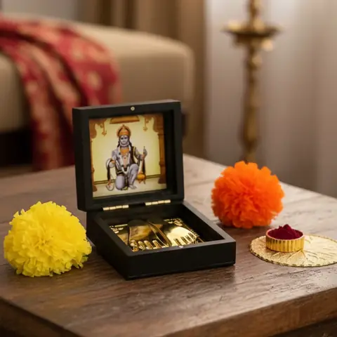 The box on a wooden table with marigolds and kumkum