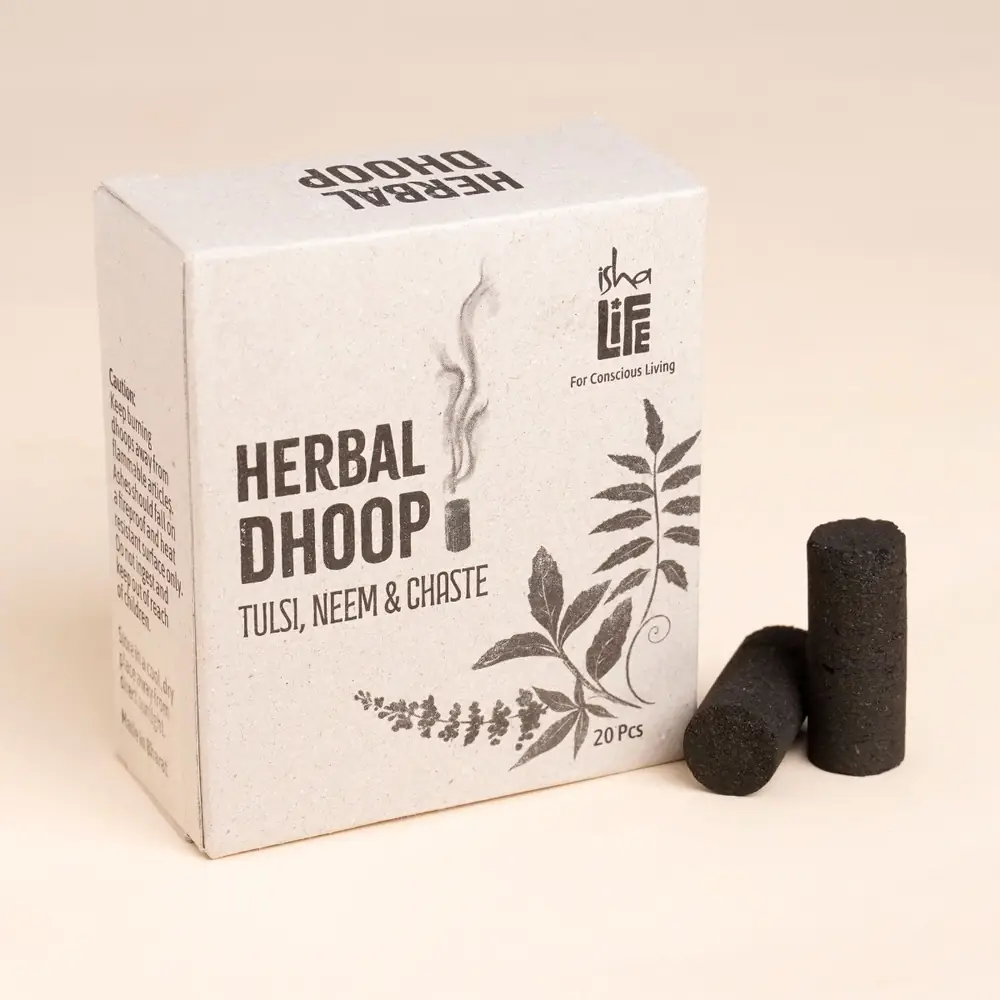 Box of herbal dhoop with two cylinders beside it
