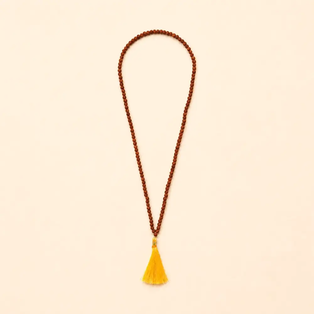 Five mukhi rudraksha mala with a yellow tassel laid in a long loop