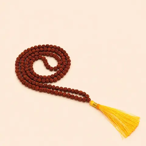 The mala coiled with its tassel